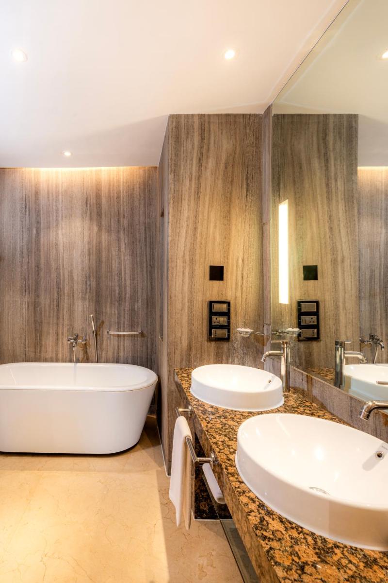 a bathroom with two sinks and a tub at Hyatt Regency Pune Hotel & Residences in Pune