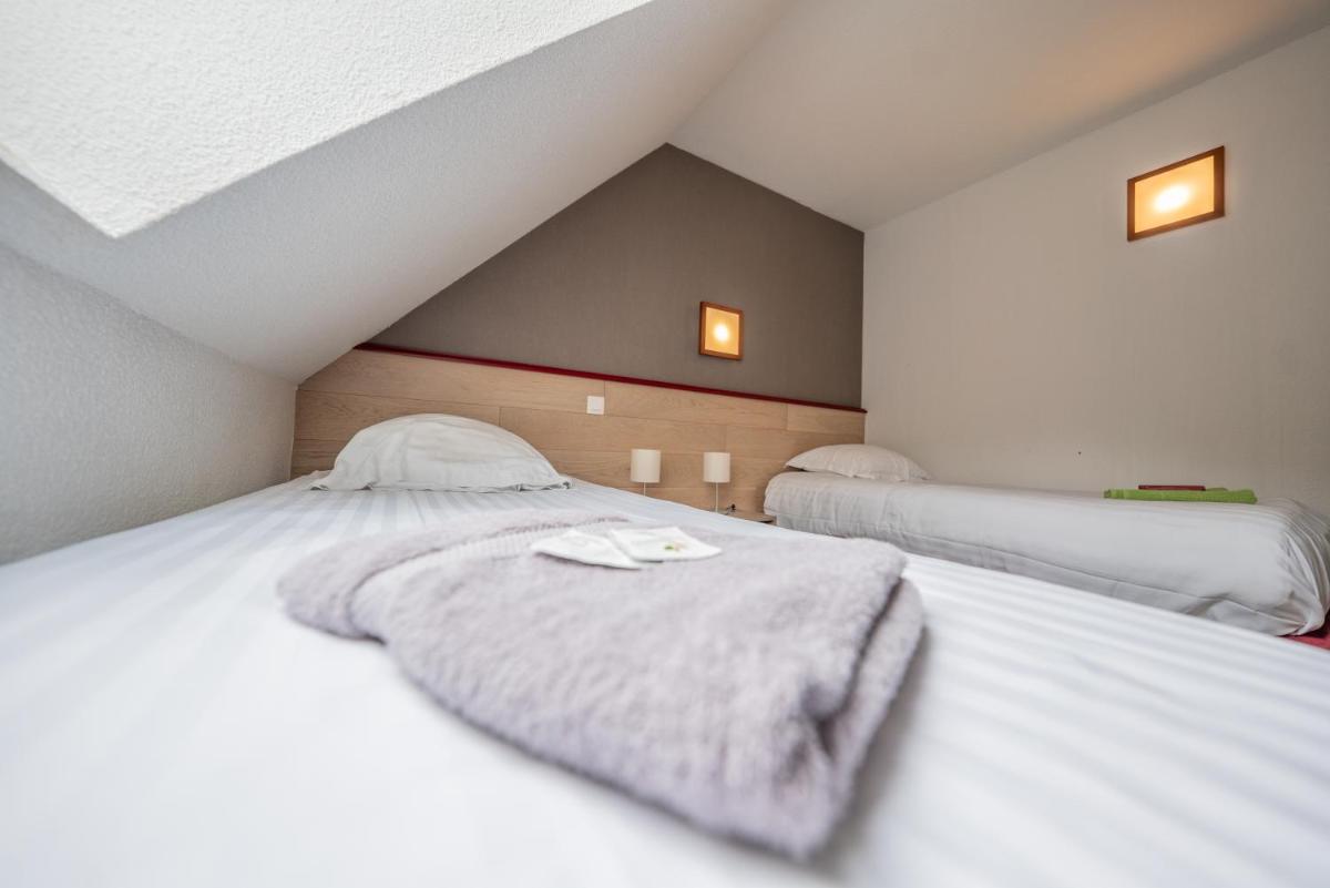 Un ou plusieurs lits dans un hébergement de l'établissement Sancy Resort