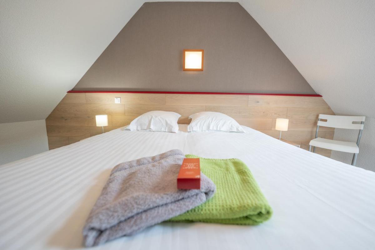 Un ou plusieurs lits dans un hébergement de l'établissement Sancy Resort