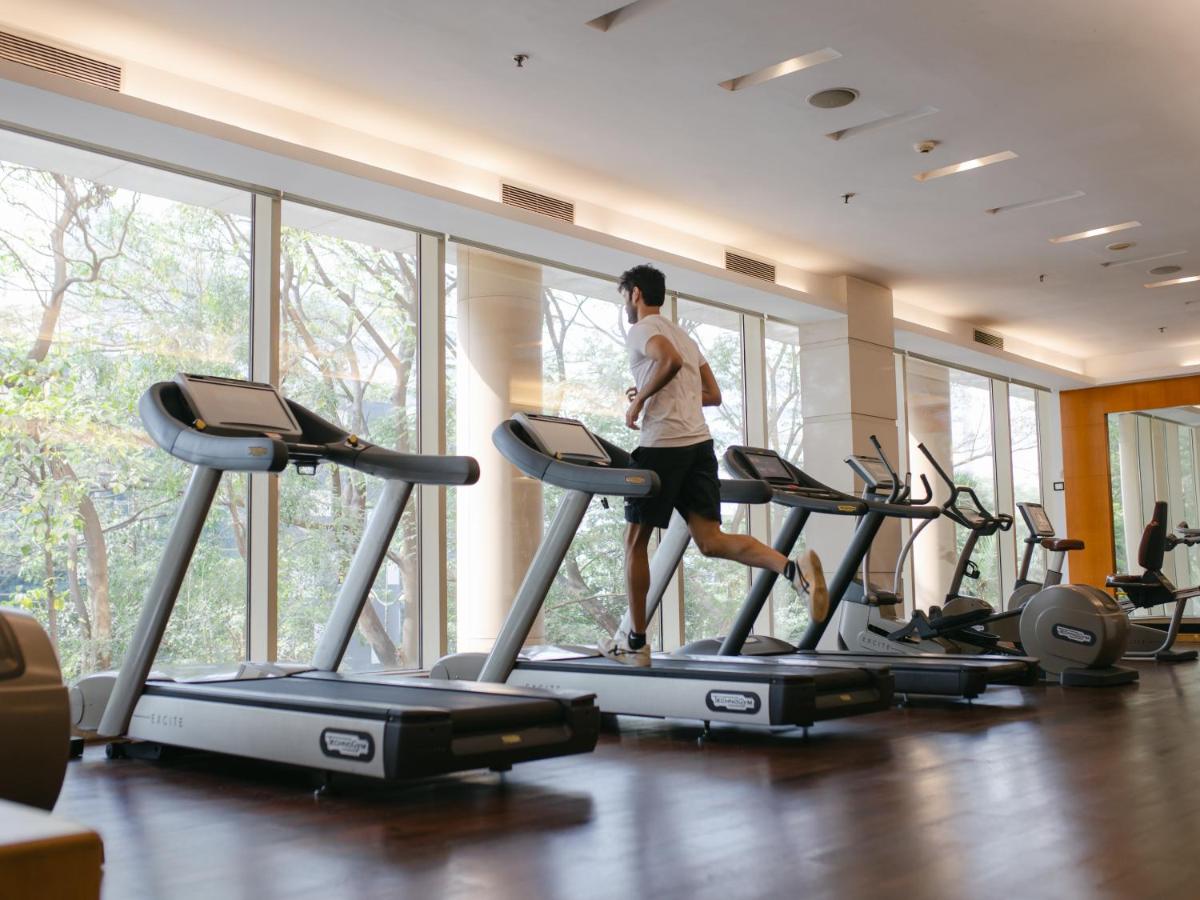 a man running on a treadmill in a gym at Hyatt Regency Pune Hotel & Residences in Pune
