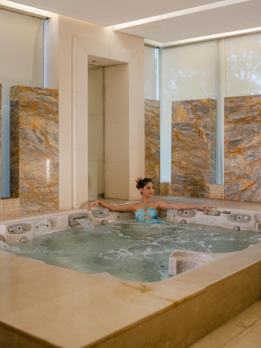 a woman in a jacuzzi bathtub at Hyatt Regency Pune Hotel & Residences in Pune