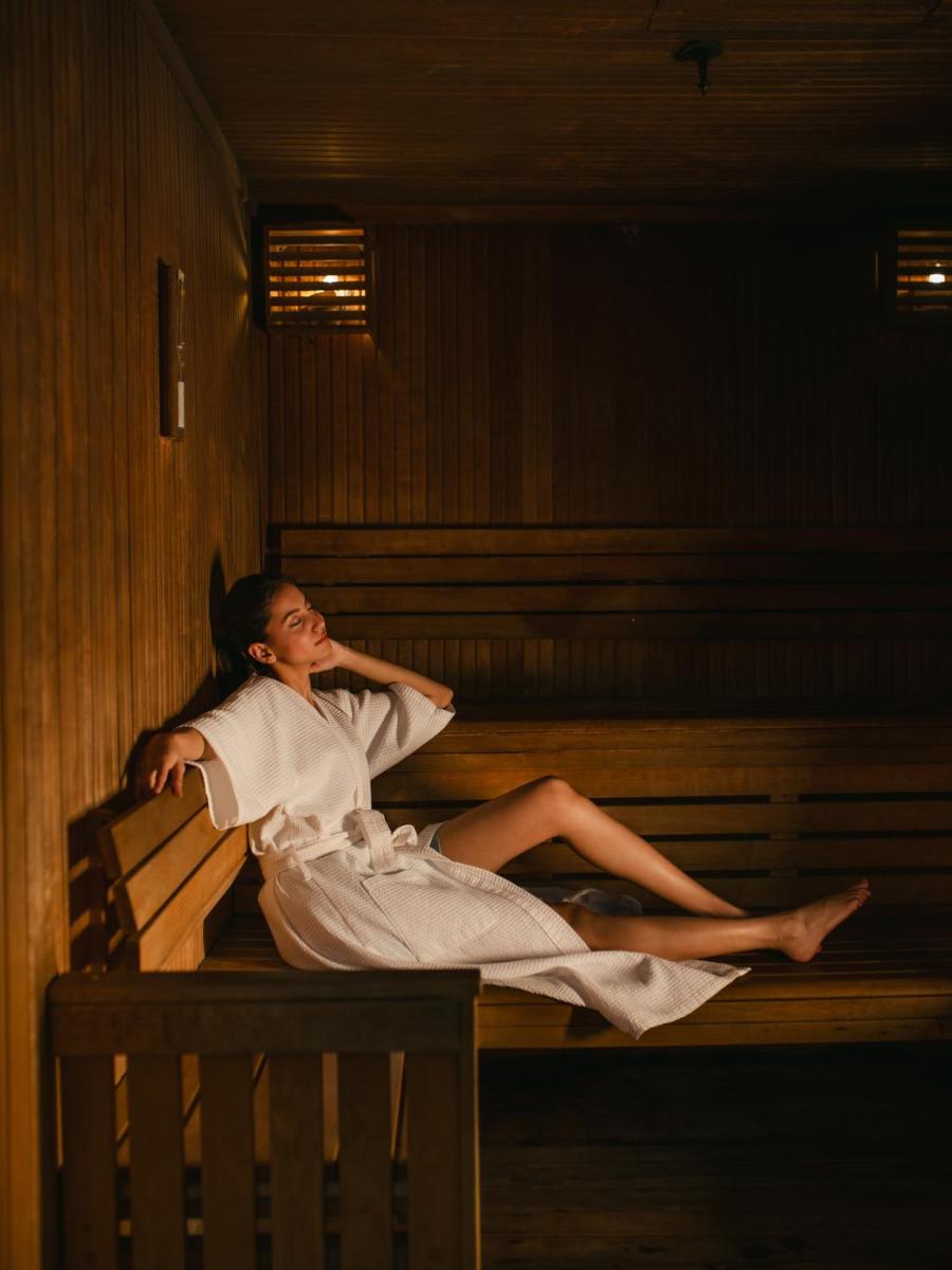 a woman in a white dress sitting on a bench at Hyatt Regency Pune Hotel & Residences in Pune
