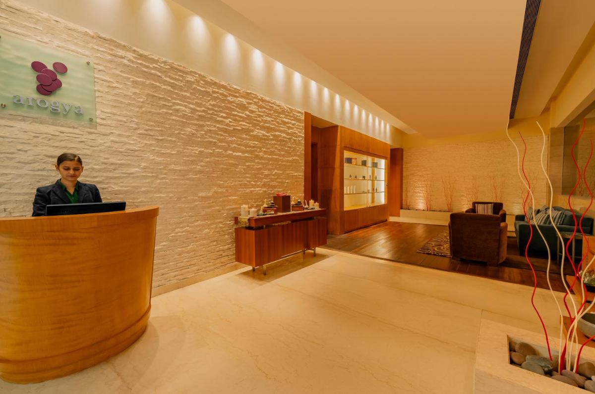 a woman standing at a counter in a lobby at Hyatt Regency Pune Hotel & Residences in Pune
