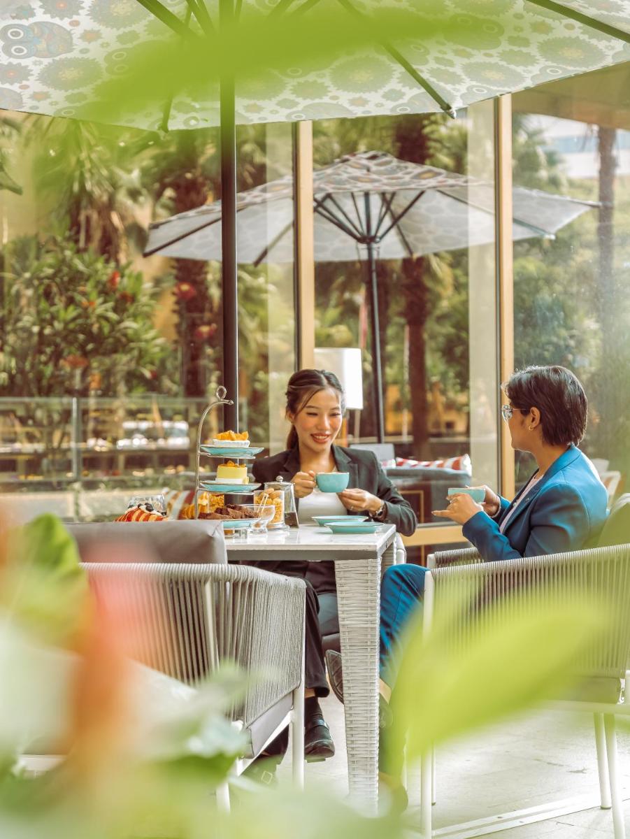 two women sitting at a table in a restaurant at Hyatt Regency Pune Hotel & Residences in Pune