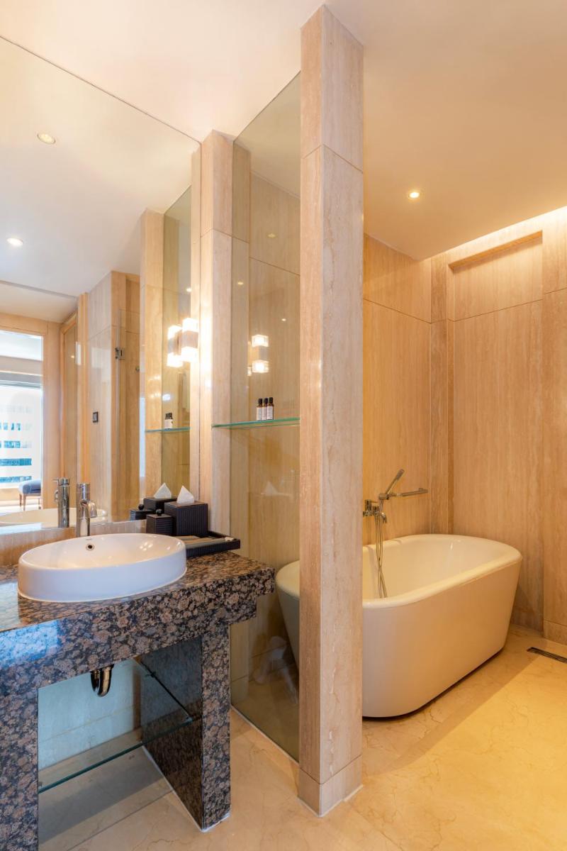 a bathroom with a large tub and a sink at Hyatt Regency Pune Hotel & Residences in Pune