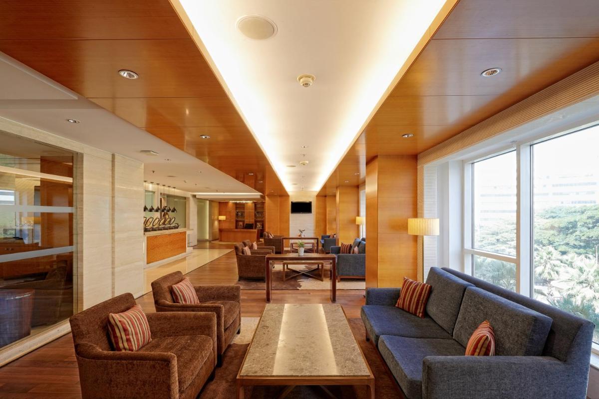 a living room with couches and a table at Hyatt Regency Pune Hotel & Residences in Pune