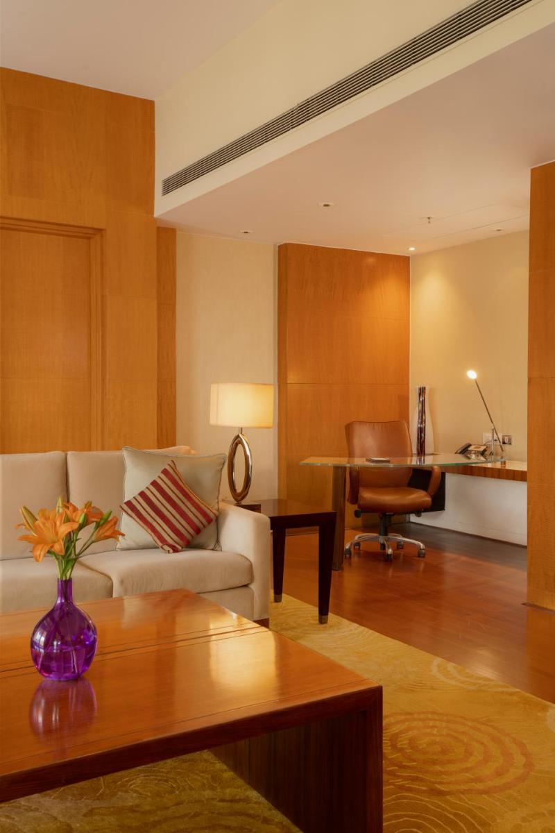 a living room with a couch and a table at Hyatt Regency Pune Hotel & Residences in Pune