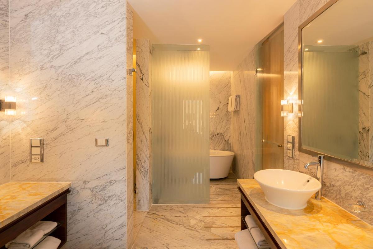 a bathroom with a sink and a toilet and a shower at Hyatt Regency Pune Hotel & Residences in Pune