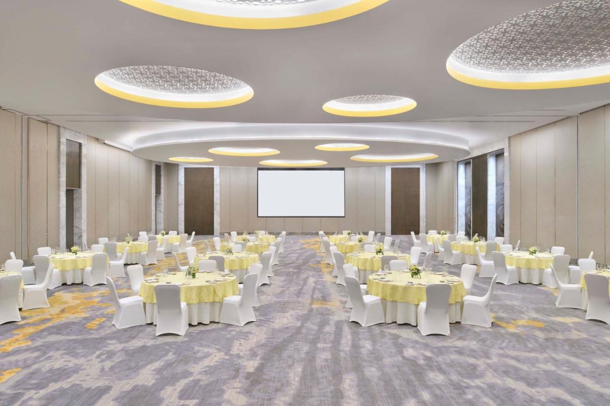 a banquet hall with white tables and white chairs at The Westin Resort & Spa Himalayas in Rishīkesh