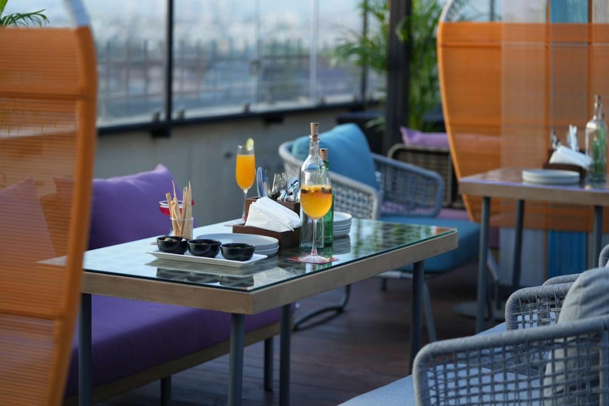 a table with two glasses of orange juice on it at Hilton Chennai in Chennai