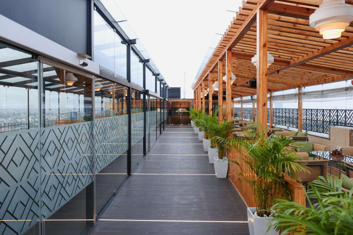 a balcony with potted plants on a building at Hilton Chennai in Chennai