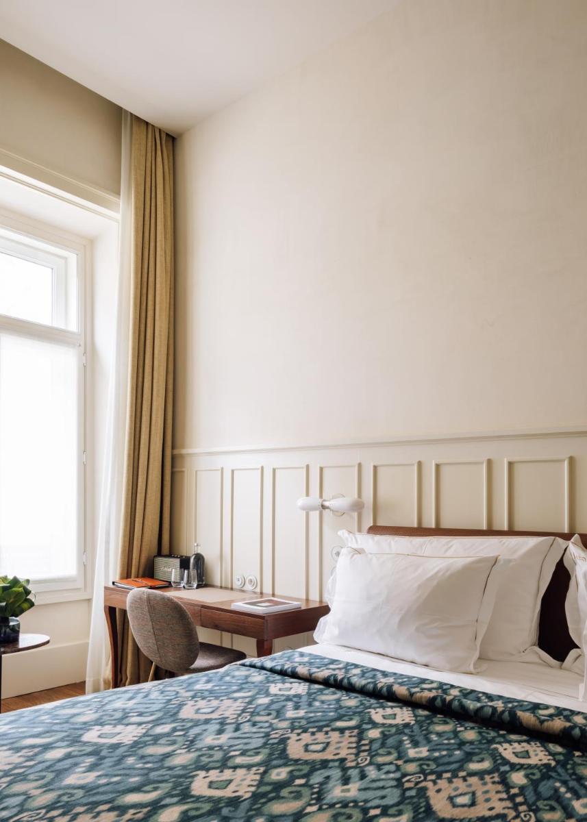 Uma cama ou camas num quarto em Bairro Alto Hotel
