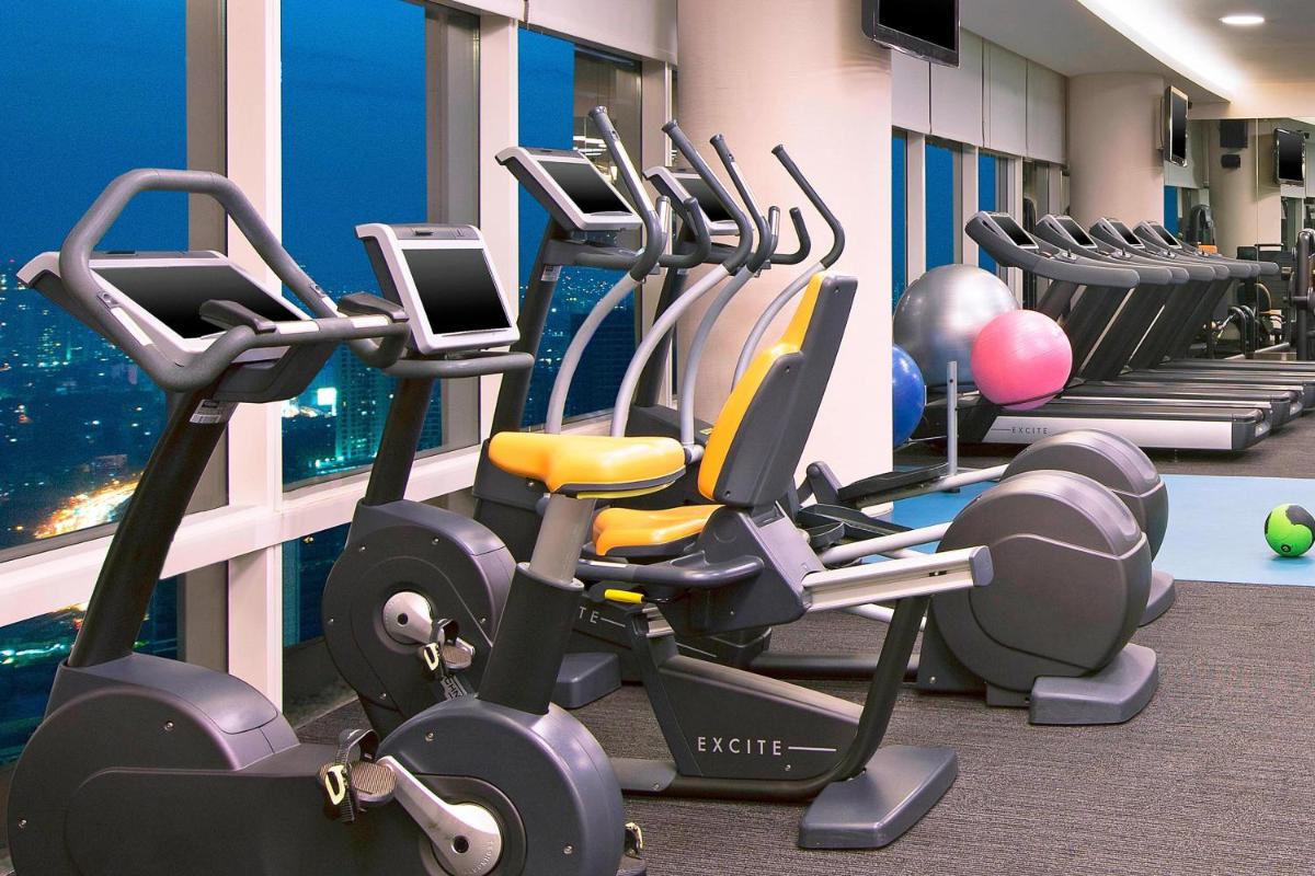 a gym with a bunch of cardio machines at The Westin Mumbai Garden City in Mumbai