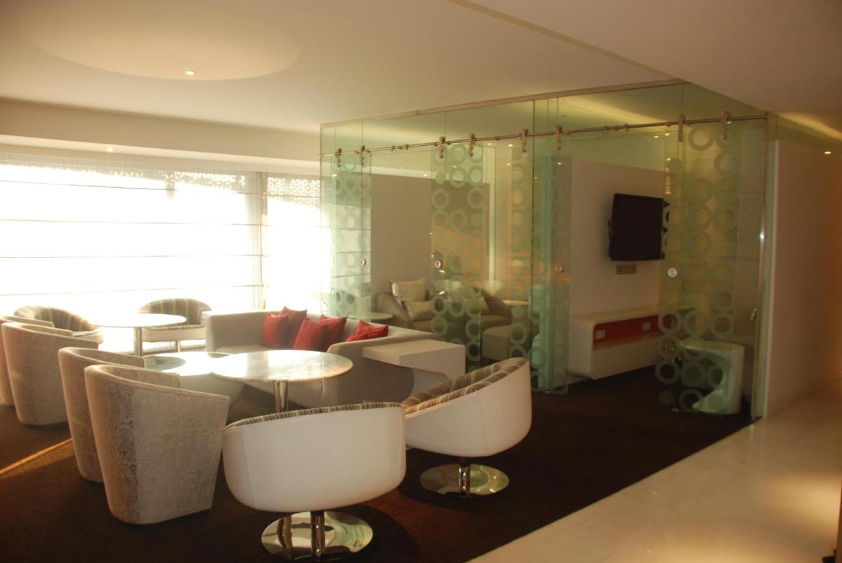 a living room with a table and chairs at The Park Hyderabad, Banjara Hills near Hussain Sagar Lake in Hyderabad a living room with a table and chairs at The Park Hyderabad, Banjara Hills near Hussain Sagar Lake in Hyderabad