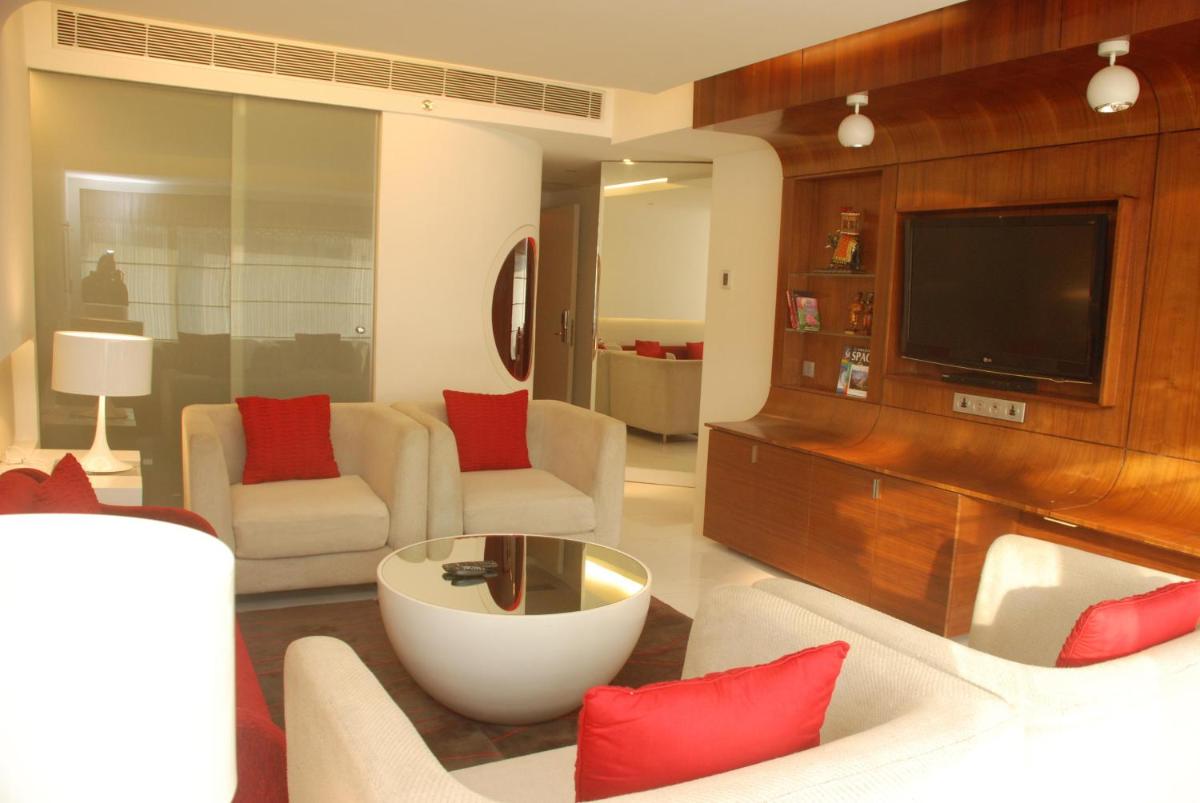 a living room with red pillows and a television at The Park Hyderabad, Banjara Hills near Hussain Sagar Lake in Hyderabad a living room with red pillows and a television at The Park Hyderabad, Banjara Hills near Hussain Sagar Lake in Hyderabad