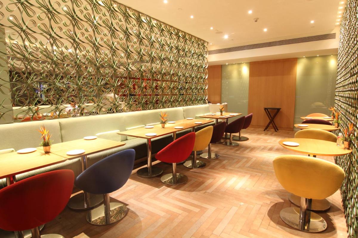 a row of tables and chairs in a restaurant at The Park Hyderabad, Banjara Hills near Hussain Sagar Lake in Hyderabad a row of tables and chairs in a restaurant at The Park Hyderabad, Banjara Hills near Hussain Sagar Lake in Hyderabad