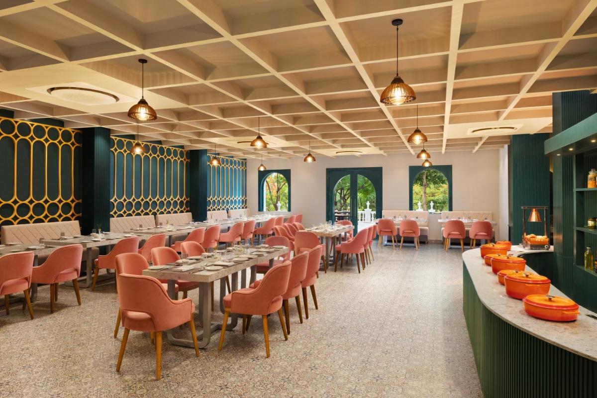 a large dining room with tables and chairs at Essentia Luxury Resort & Spa Udaipur in Udaipur