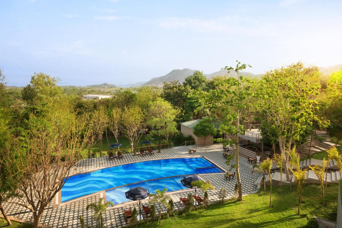 an overhead view of a swimming pool in a yard at Essentia Luxury Resort & Spa Udaipur in Udaipur