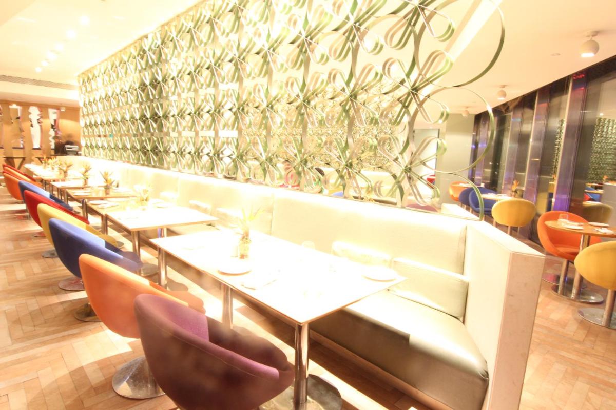 a row of tables and chairs in a restaurant at The Park Hyderabad, Banjara Hills near Hussain Sagar Lake in Hyderabad a row of tables and chairs in a restaurant at The Park Hyderabad, Banjara Hills near Hussain Sagar Lake in Hyderabad