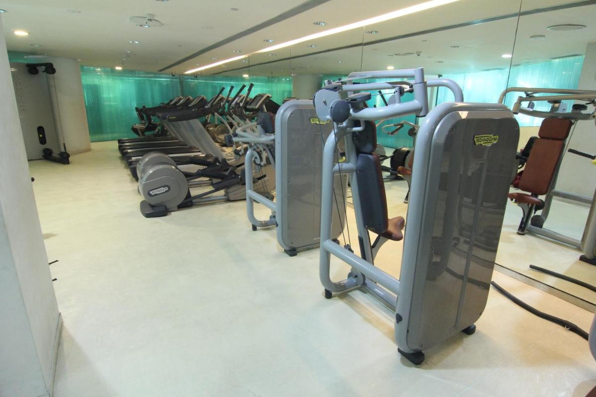 a gym with a row of treadmills and ellipticals at The Park Hyderabad, Banjara Hills near Hussain Sagar Lake in Hyderabad a gym with a row of treadmills and ellipticals at The Park Hyderabad, Banjara Hills near Hussain Sagar Lake in Hyderabad
