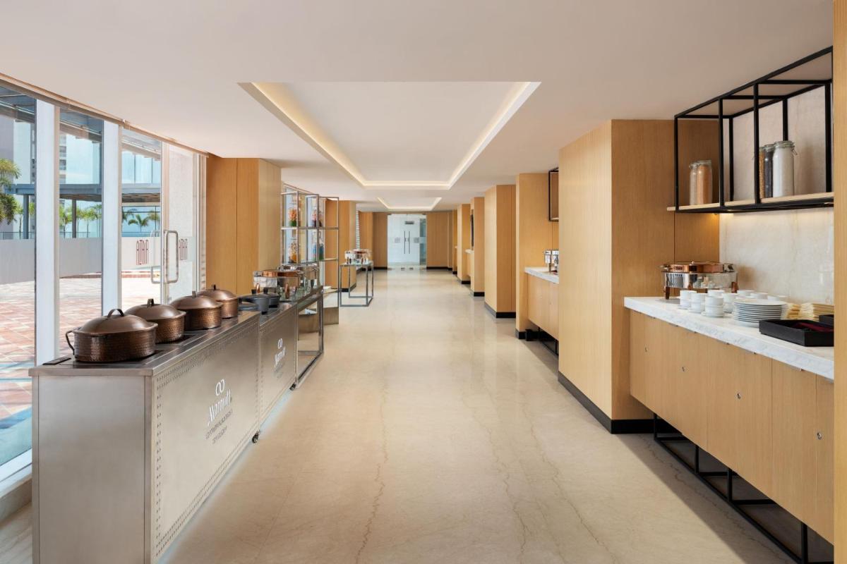 a kitchen with a long hallway with pots and pans at Marriott Executive Apartments Hyderabad in Hyderabad