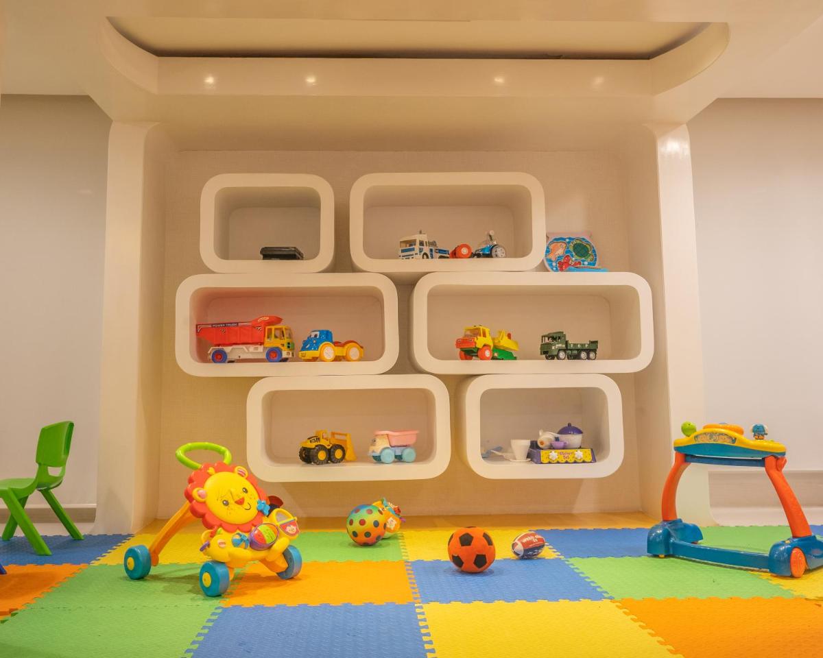 a play room with shelves and toys on the floor at Hilton Bangalore Embassy GolfLinks in Bengaluru