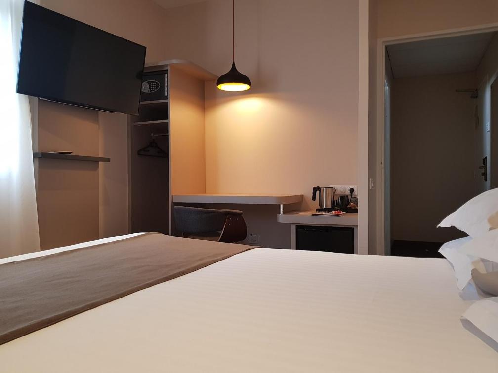 Un ou plusieurs lits dans un hébergement de l'établissement Brit Hotel de Grignan Vichy
