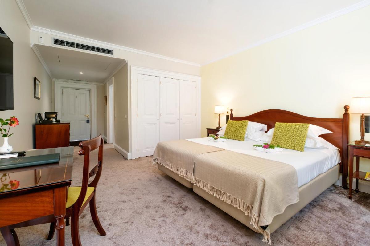 Uma cama ou camas num quarto em Casa Velha do Palheiro Relais & Chateaux