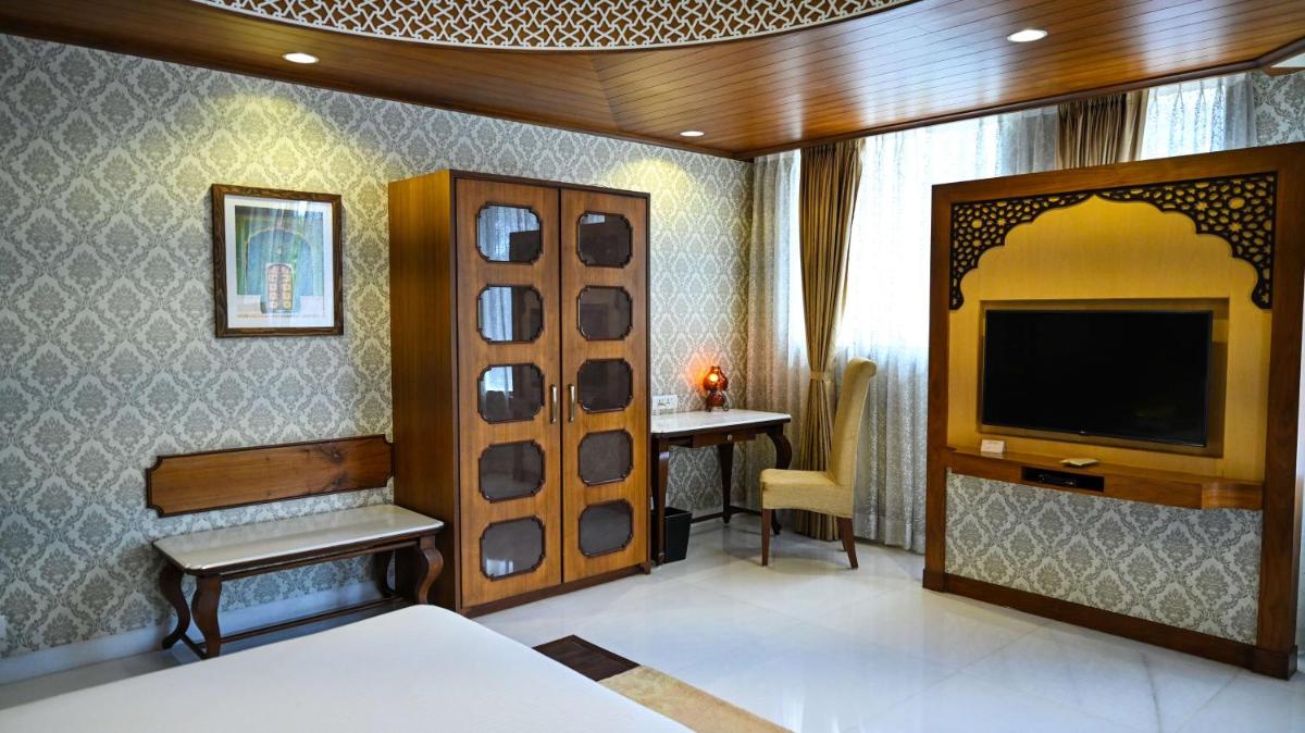 a bedroom with a bed and a tv in a room at Radisson Jodhpur in Jodhpur