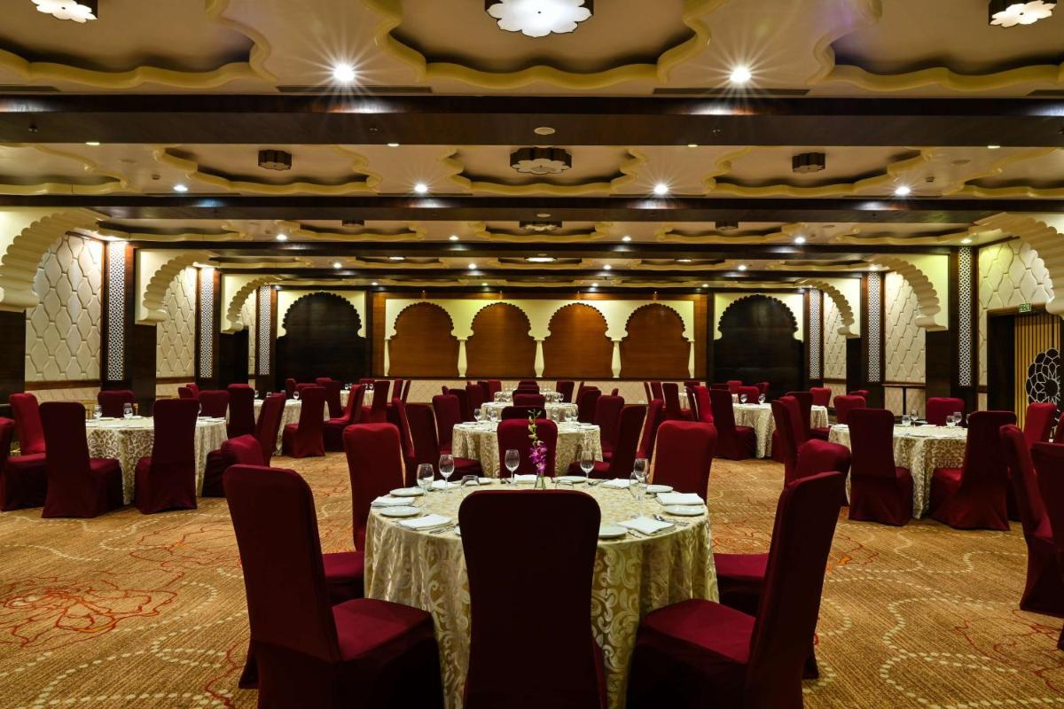 a banquet hall with tables and chairs in a room at Radisson Jodhpur in Jodhpur