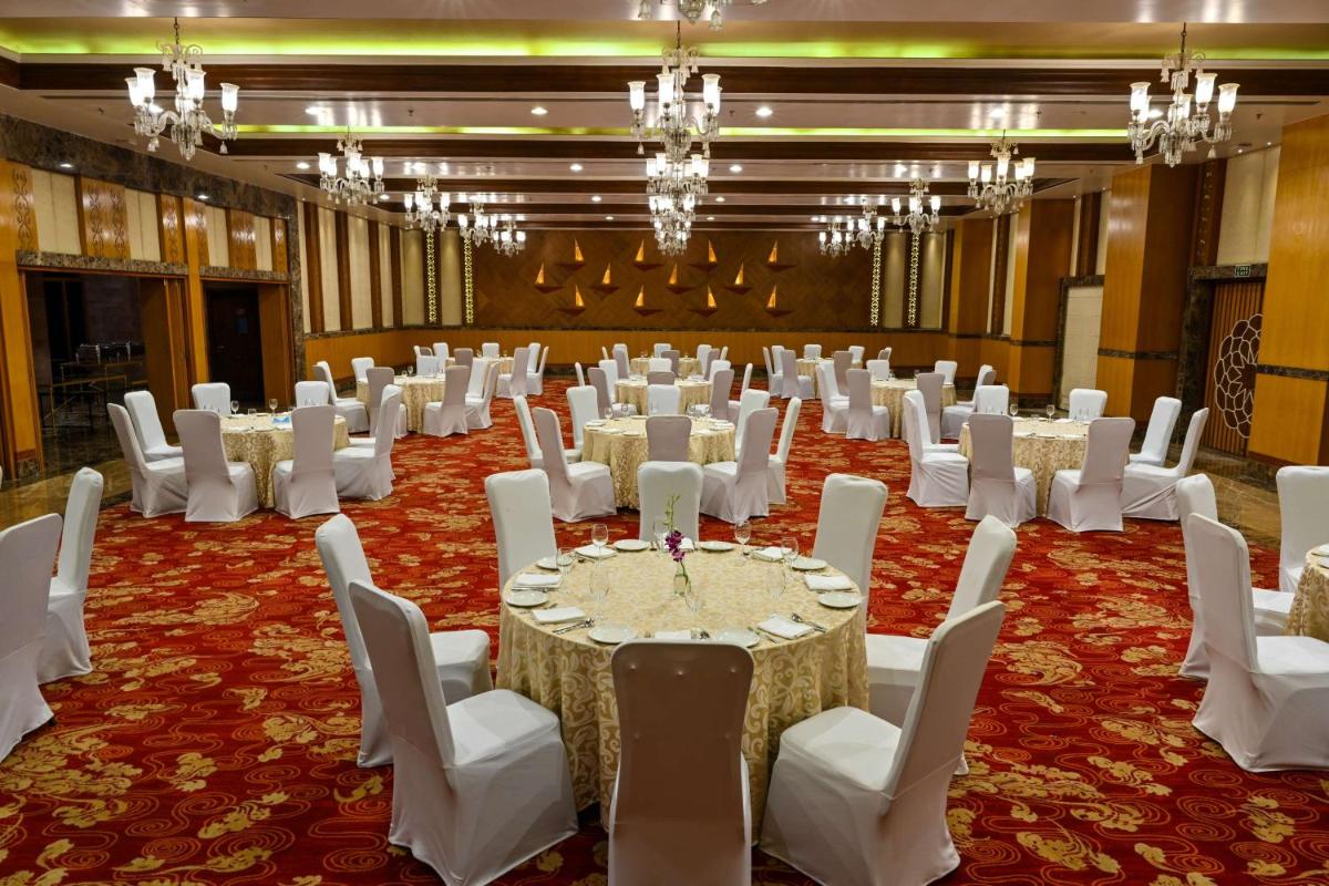 a banquet hall with white tables and white chairs at Radisson Jodhpur in Jodhpur