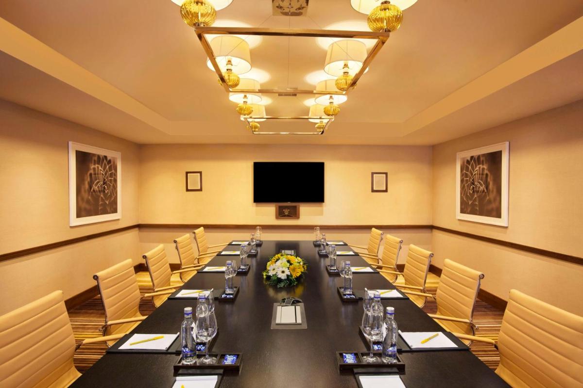 a large conference room with a long table and a flat screen tv at Hilton Garden Inn, Trivandrum in Trivandrum
