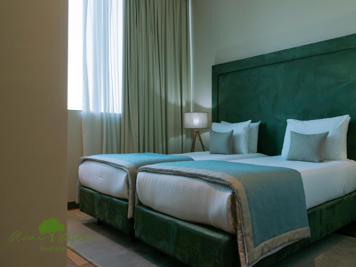 Uma cama ou camas num quarto em Olive Nature Hotel & SPA - Quinta Valle de Passos