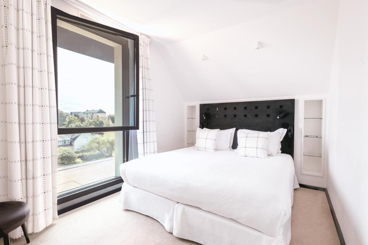 Un ou plusieurs lits dans un hébergement de l'établissement L'Agapa Hôtel - Spa Codage