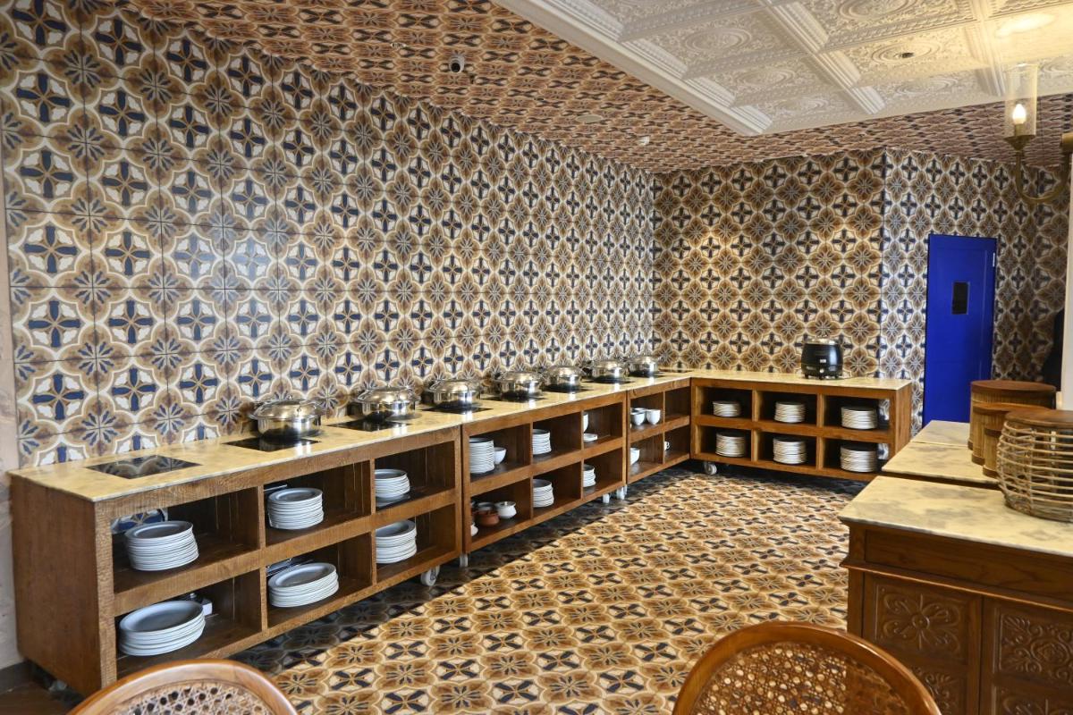 a kitchen with wooden cabinets and a wall with tiles at Zone Connect by The Park Saket New Delhi in New Delhi a kitchen with wooden cabinets and a wall with tiles at Zone Connect by The Park Saket New Delhi in New Delhi