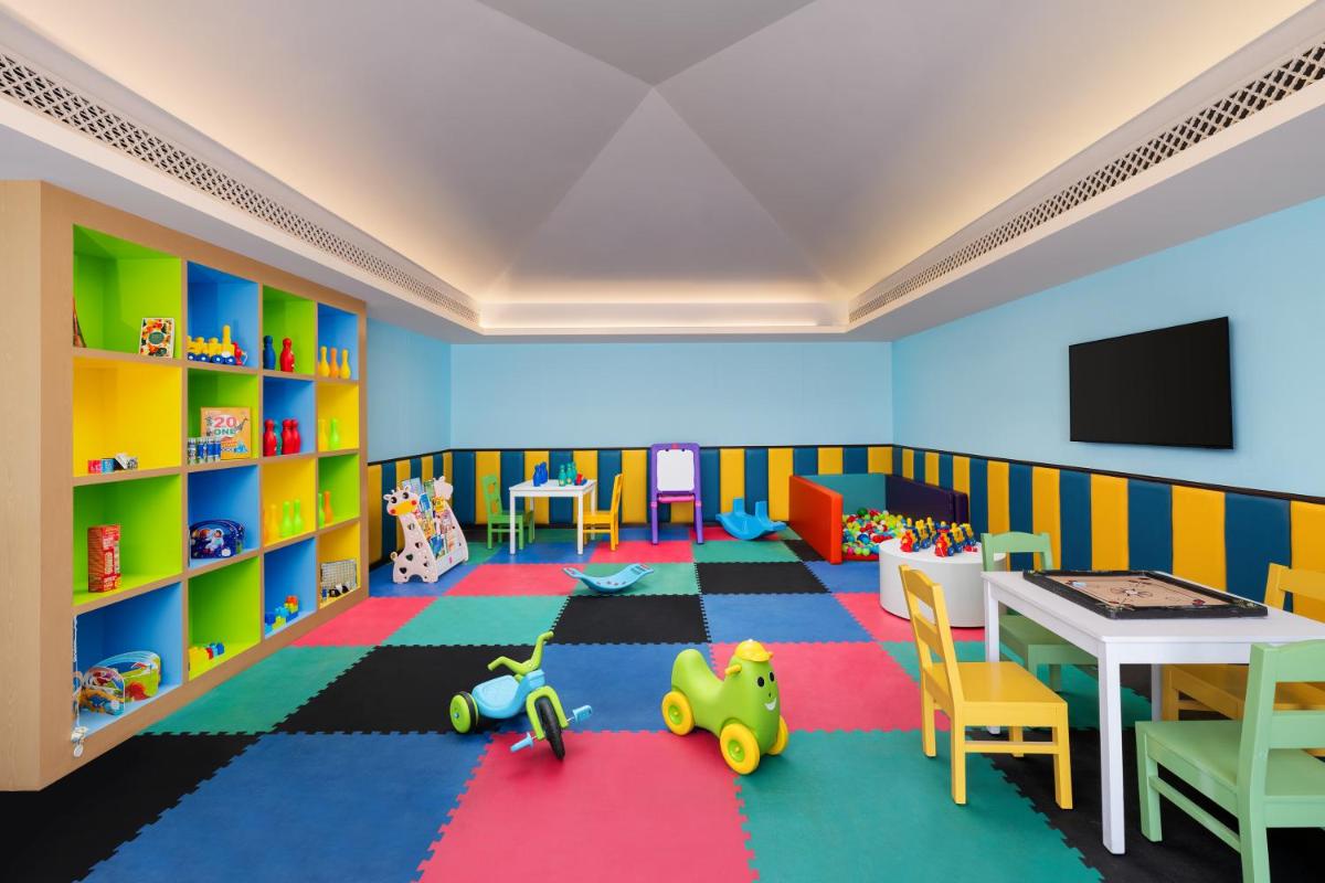 a childs room with a table and chairs at Pilibhit House, Haridwar – IHCL SeleQtions in Haridwār