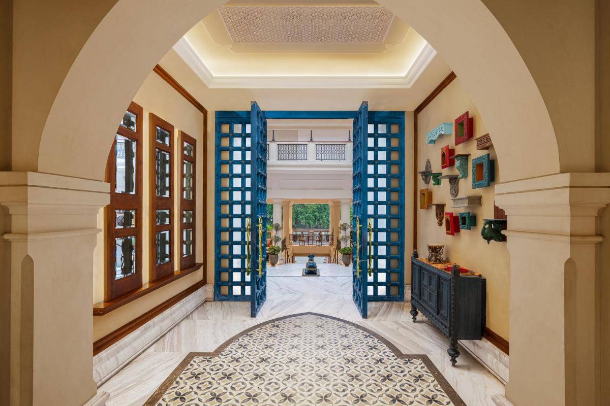 an archway in a home with a blue door at Pilibhit House, Haridwar – IHCL SeleQtions in Haridwār