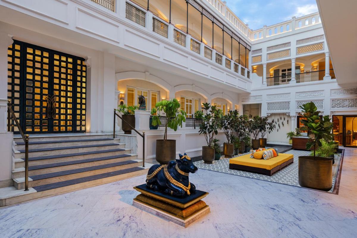 a large building with a lobby with potted plants at Pilibhit House, Haridwar – IHCL SeleQtions in Haridwār