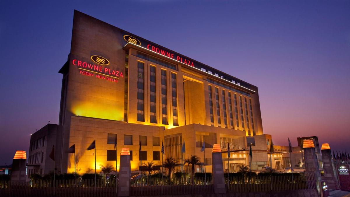 a building with a sign on the side of it at Crowne Plaza New Delhi Okhla by IHG in New Delhi