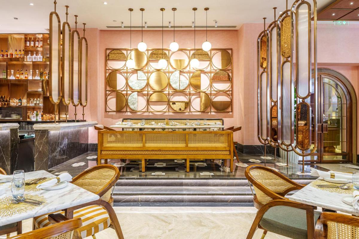 a restaurant with a piano in the middle at Crowne Plaza Today Gurugram by IHG in Gurgaon