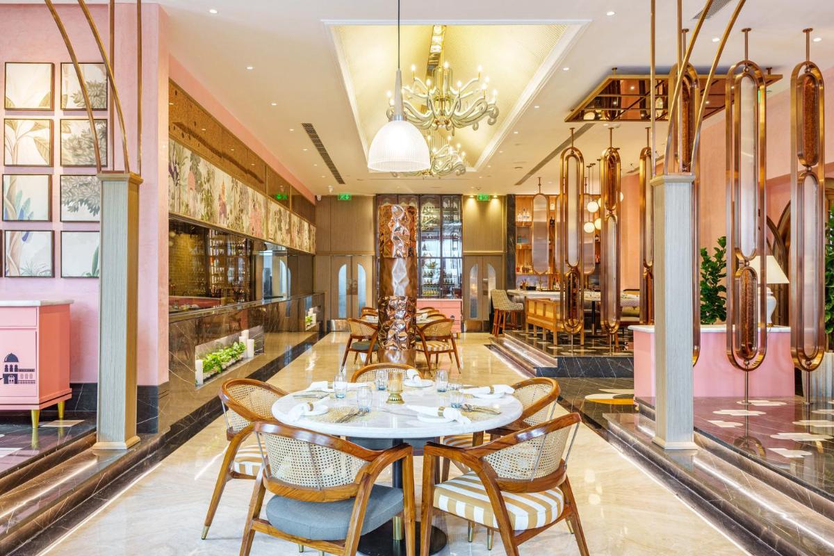 a dining room with a table and chairs at Crowne Plaza Today Gurugram by IHG in Gurgaon