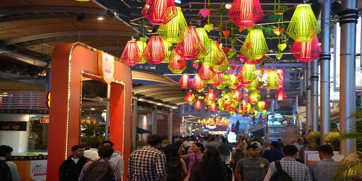a crowd of people walking in a shopping mall with red lanterns at Crowne Plaza Today Gurugram by IHG in Gurgaon