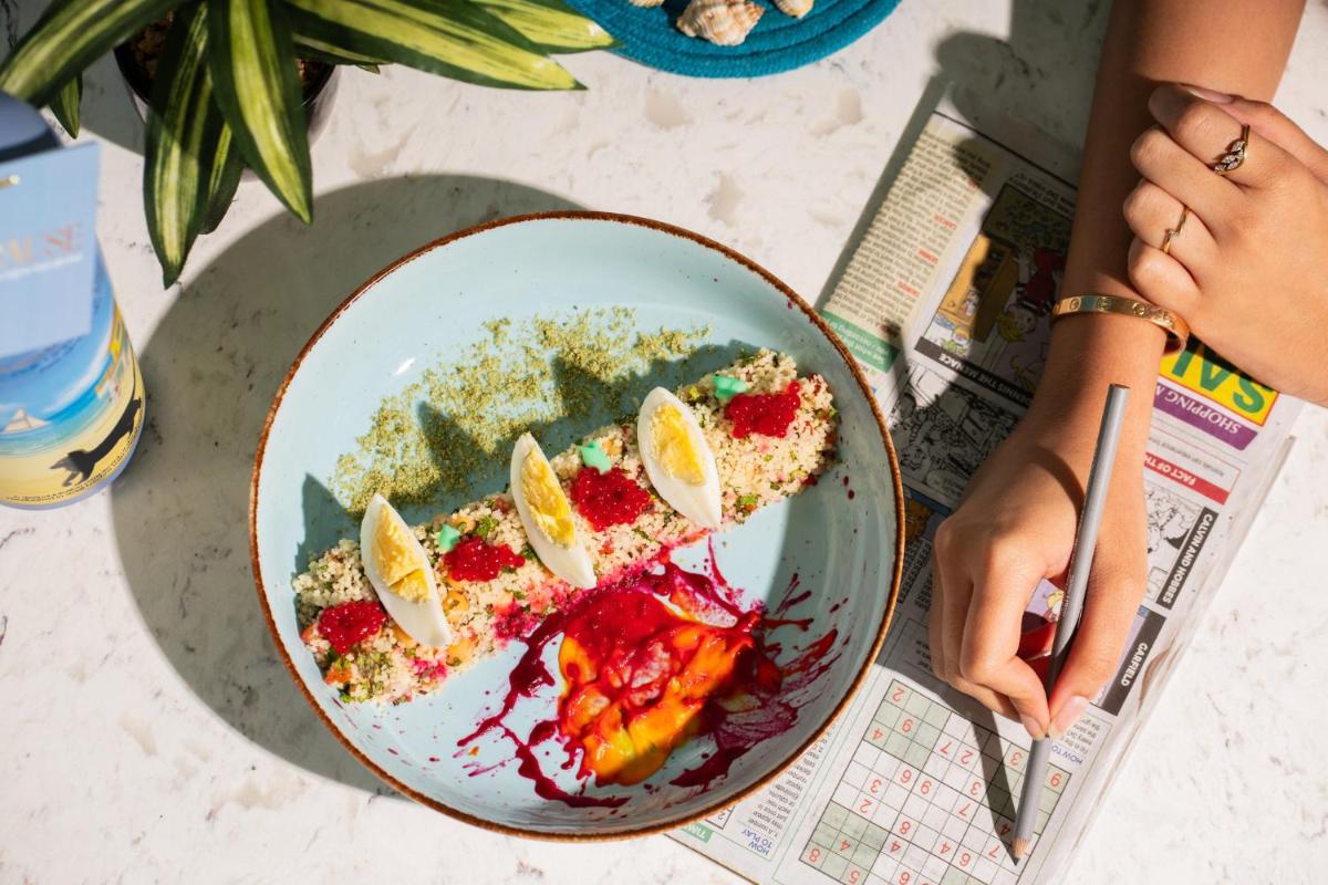 a plate of food with fruit on a table at Crowne Plaza Ahmedabad City Centre by IHG in Ahmedabad