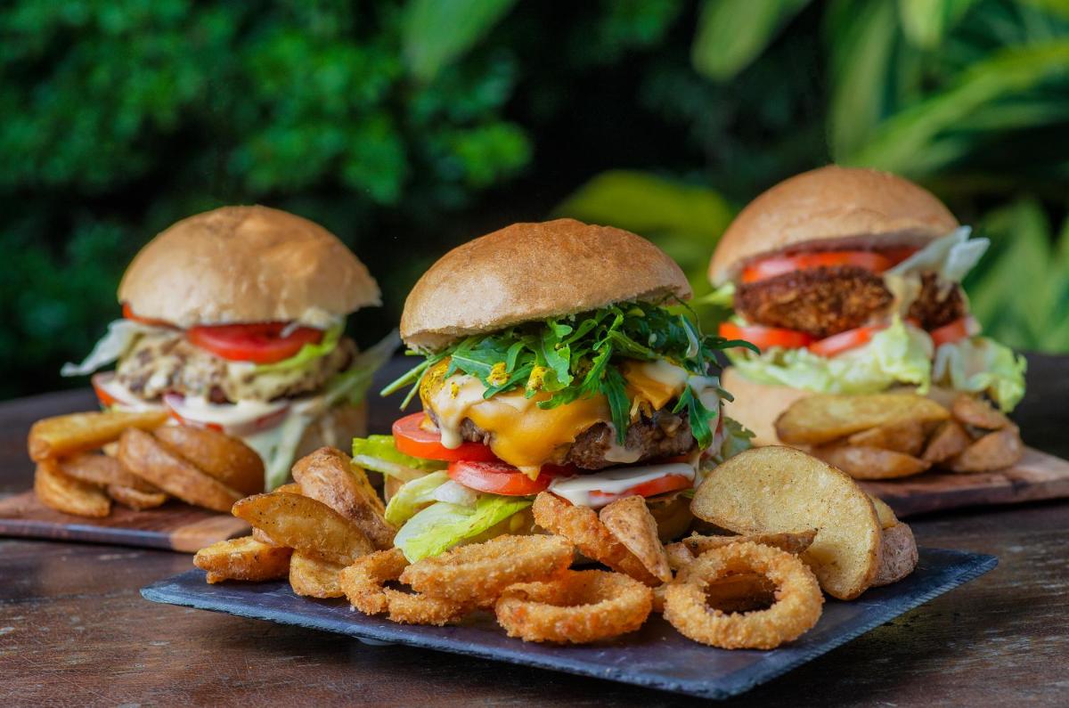 three sandwiches and some fries on a plate at The Park Kolkata in Kolkata