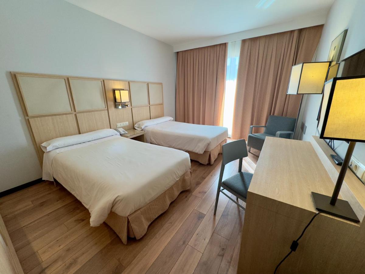 Cama o camas de una habitación en Hotel Isla de La Garena