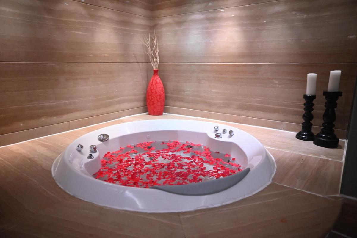 a bath tub filled with red sprinkles in a room at The Park Kolkata in Kolkata