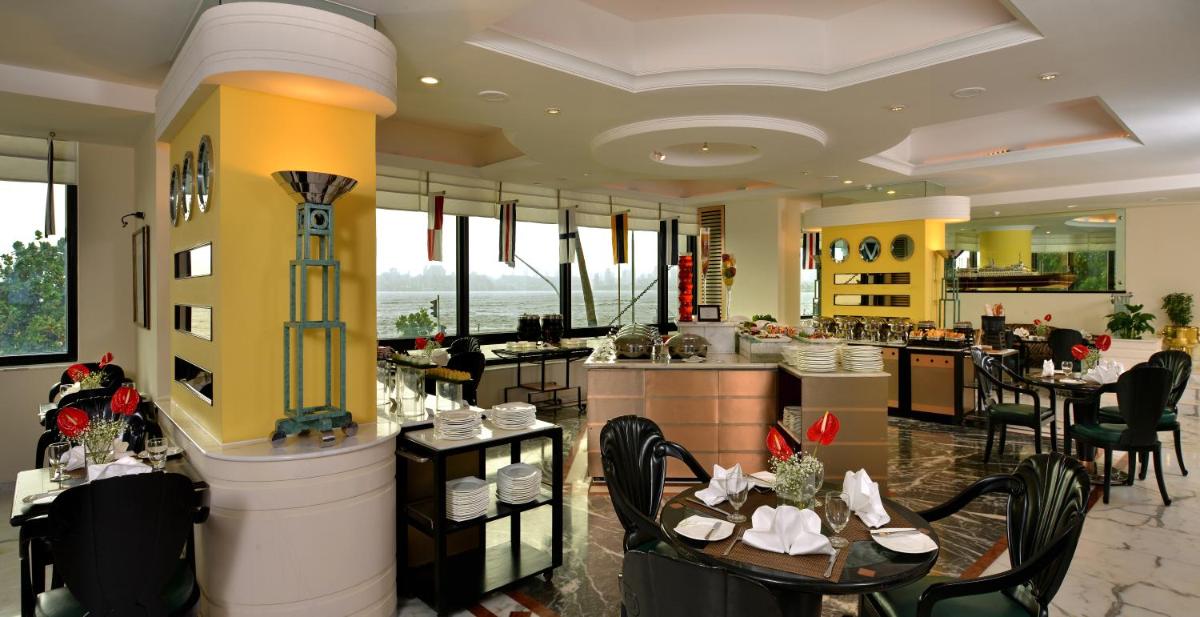 a restaurant with tables and chairs and a bar at Hotel Marine Plaza in Mumbai