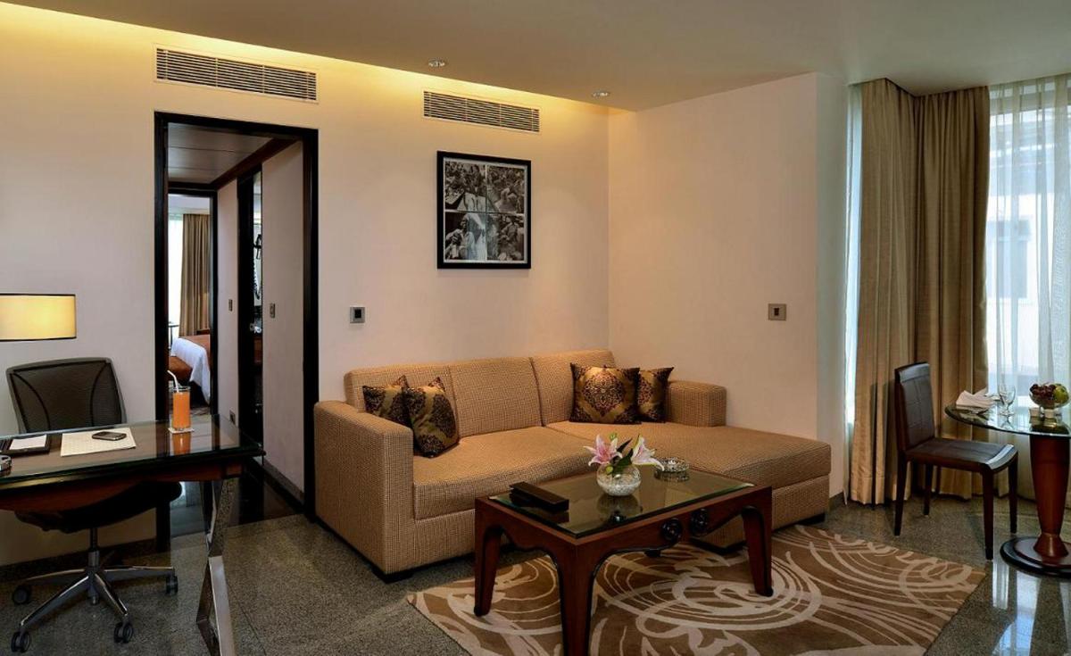 a living room with a couch and a table at Hotel Marine Plaza in Mumbai