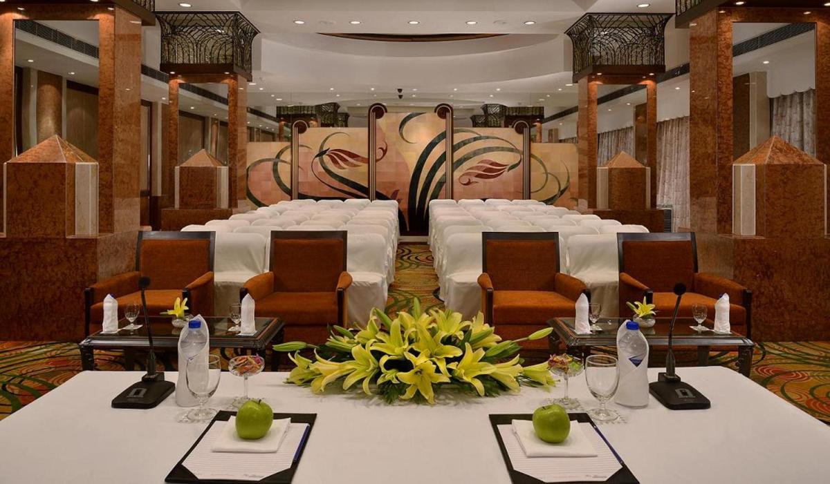 a room with tables and chairs and a set up for a banquet at Hotel Marine Plaza in Mumbai