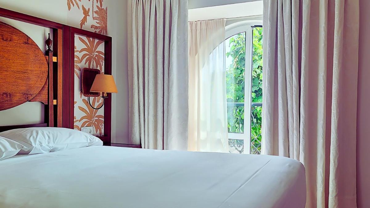 Uma cama ou camas num quarto em Grande Hotel das Caldas da Felgueira